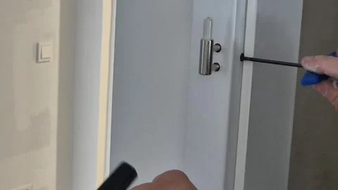 Slow Motion Close Up of Adjusting Door Hinge Stock Footage 335709992