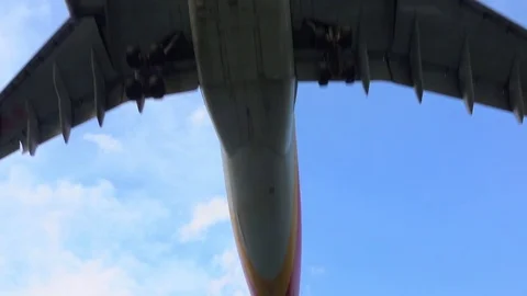 SLOW MOTION CLOSE UP: Airplane jet flying directly over camera at airport Stock Footage 82258428