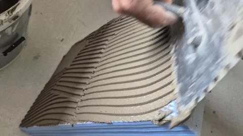 Slow Motion Close Up of Applying Cement Adhesive to XPS Board Stock Footage 340643672
