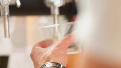 Slow motion close up of bartender hands pours beer into a plastic glass. Close Stock Footage 279551034