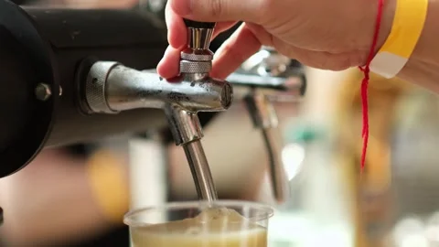 Slow motion close up of bartender hands pours beer into a plastic glass. Close Stock Footage 279551073
