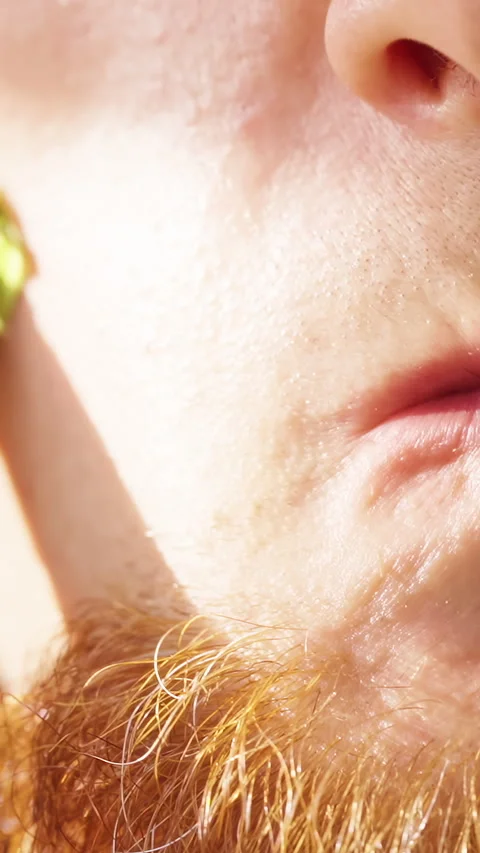 Slow Motion Close Up of a Bearded Man Shaving Facial Hair on His Cheek with an E Stock Footage 342596201