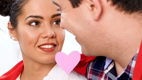 Slow motion close up on beautiful couple playing with pink hearts Stock Footage 84896516