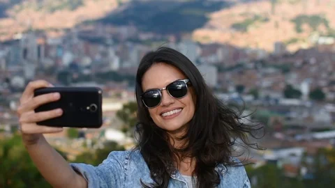 Slow motion close up of beautiful smiling girl with sunglasses taking selfie Stock Footage 101207792