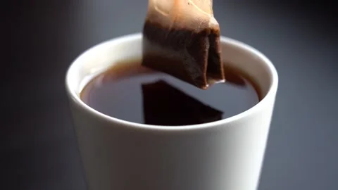 Slow Motion Close-up Black Tea Brewing in a White Mug Stock Footage 147872389