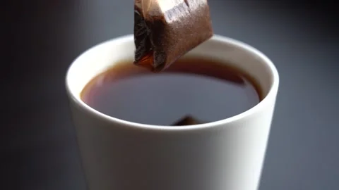 Slow Motion Close-up Black Tea Brewing in a White Mug Stock Footage 151857333