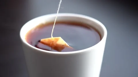 Slow Motion Close-up Black Tea Brewing in a White Mug Stock Footage 156936134