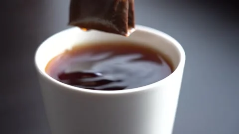 Slow Motion Close-up Black Tea Brewing in a White Mug Stock Footage 167885938
