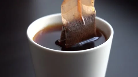 Slow Motion Close-up Black Tea Brewing in a White Mug Stock Footage 167886815