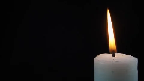 Slow motion close up blowing out candle in corner isolated black background Stock Footage 278958429