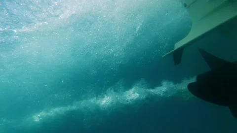 Slow-motion close up of boat propeller spinning underwater producing air 動画素材 164964474