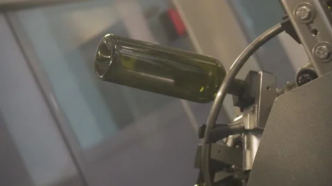 Slow motion, close-up of a bottle on an Automatic conveyor. Stock Footage 155428989