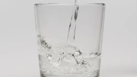 Slow motion close up bottle of water being poured into glass Sparkling water Stock Footage 265846446