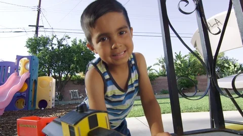 Slow Motion Close-up of boy smiling at the camera with toys around Stock Footage 92062859