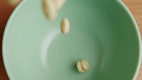 Slow Motion close up Breakfast Cereal Falling into Bowl Stock Footage 128102459