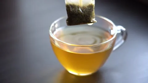 Slow Motion Close-up Brew Green Tea in Transparent Mug Stock Footage 167214243