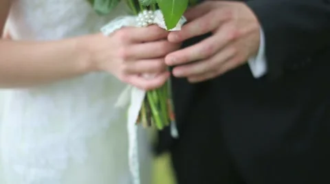 Slow motion. Close-up. the bride holding a bouquet, the groom puts his hand on t Stock Footage 47841409