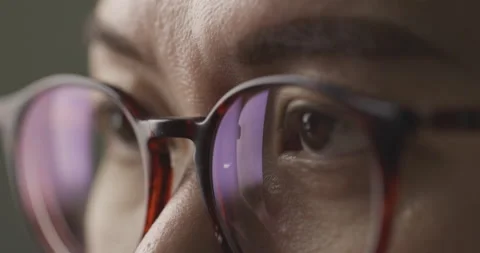 Slow motion close-up brown eye with glasses is opening and looking. Stock Footage 143821906