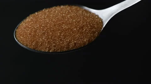 Slow Motion Close Up brown Sugar or  Erythritol sugar Falling Off Spoon Stock Footage 175311434