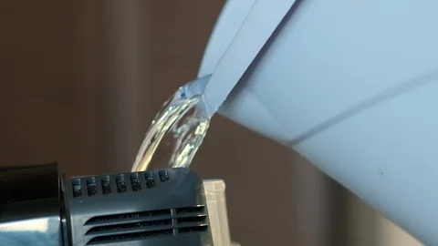 Slow motion close-up from bucket pour solution into washing vacuum cleaner Stockbeeldmateriaal 122073475