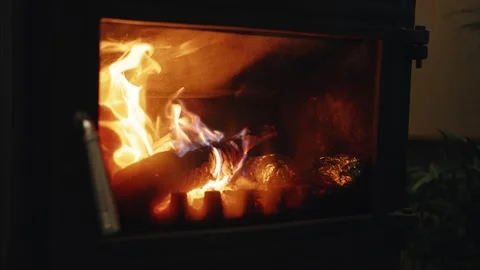 Slow Motion Close-up of Burning Firewood and Flickering Flames Inside a Metal Stock Footage 342375134