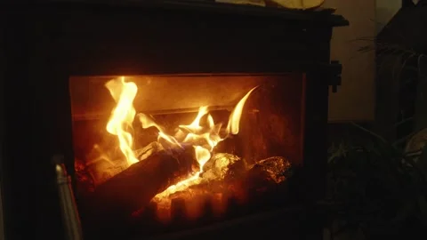 Slow Motion Close-Up of Burning Firewood and Flickering Flames in a Cast-Iron Stock Footage 342387569
