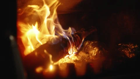 Slow Motion Close-Up of Burning Firewood and Flickering Flames Inside a Stove Stock Footage 342391229