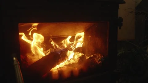 Slow Motion Close-Up of Burning Logs and Flickering Flames in a Wood Stove Stock Footage 342389622