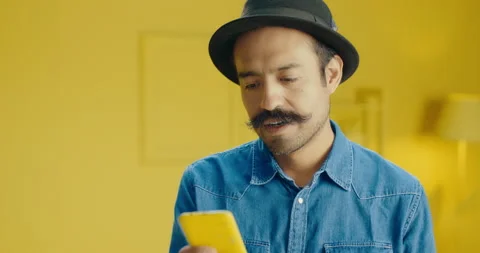 Slow motion close up of carefree Hispanic man reading message on social media Stock Footage 171372986