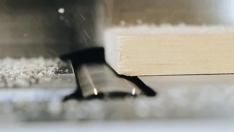 Slow motion. Close-up. Carpenter planing of board. Chips are jumping on the Stock Footage 113993823