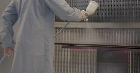 Slow motion close up of carpenter spray painting a cabinet Stockbeeldmateriaal 336055538