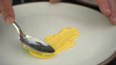 Slow Motion Close Up- Chef Smearing Colorful Yellow Sauce On A Plate Stock Footage 283666930