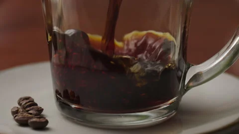 Slow motion close-up, coffee pours into a glass cup Stock Footage 237549605