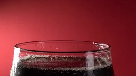 Slow Motion Close-Up Cola Pour Into Glass On A Red Background Stock-Footage 122694324