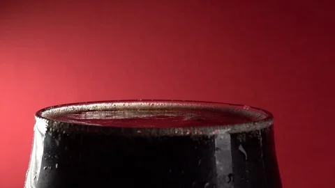 Slow Motion Close-Up Cola Pour Into Glass On A Red Background Stock-Footage 122949141