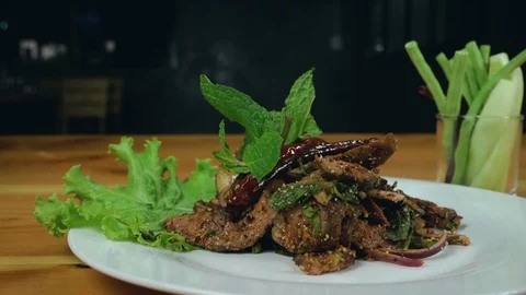 Slow motion - Close up cooking sliced grilled beef salad with pepper. Stock Footage 94176323