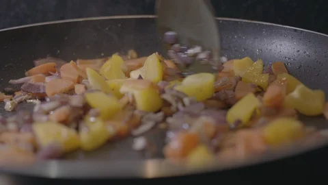 Slow Motion Close Up of Cooking Vegetables in Pan Stock Footage 128996142