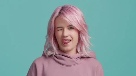 Slow motion close up cool funky girl with trendy pink hair color showing tongue Stock-Footage 231166019