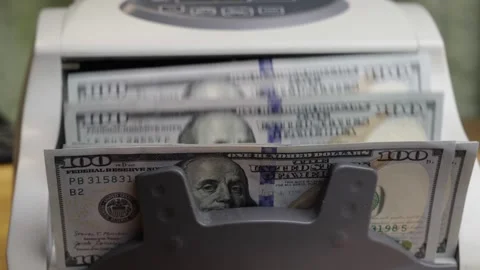 Slow motion close up of counting machine processing 100 US dollar banknotes Stock Footage 336206829