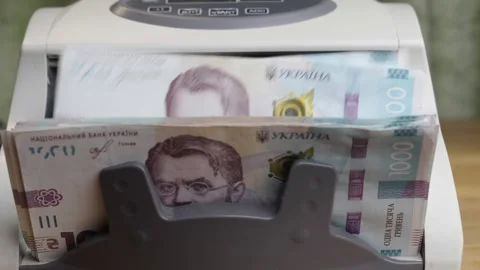 Slow motion close up of counting machine processing 1000 Ukrainian hryvnia Stock Footage 336206942
