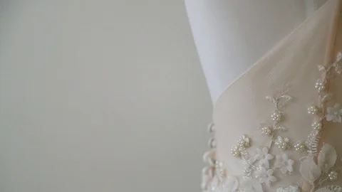 Slow motion close up of cream wedding dress embroidery Stock Footage 88706722