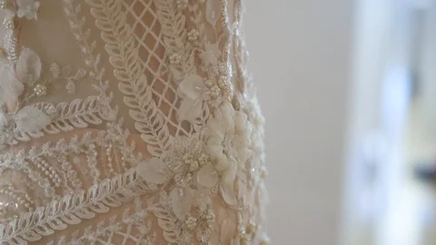Slow motion close up of cream wedding dress embroidery Stock Footage 88708003