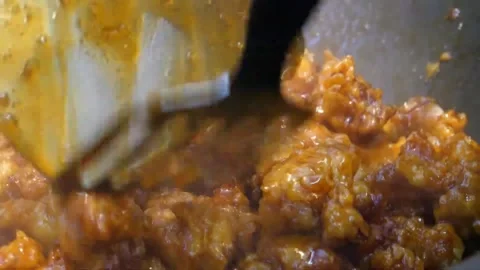 Slow Motion Close-Up of Crispy Orange Chicken Stir-Frying in a Hot Wok Video stock 343027494