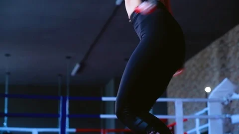 Slow motion close-up cute slim brunette woman jumps on rope training in gym 動画素材 93259807