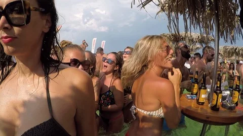Slow motion close up of dancing girls on foam beach pool party in Budva Stock Footage