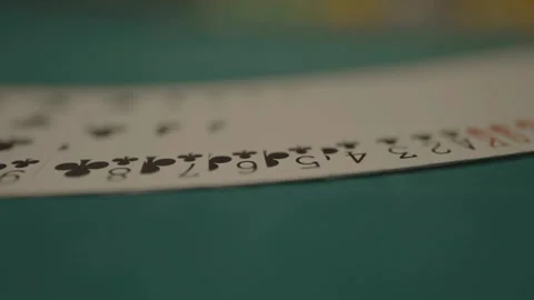 Slow motion close-up deck of cards being fanned on green felt Stock Footage 334037538