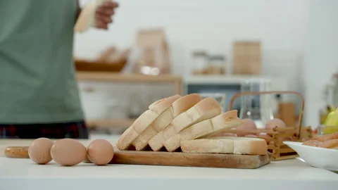 Slow motion, Close-up dining table in kitchen with fresh bread and eggs Stock Footage 240750560