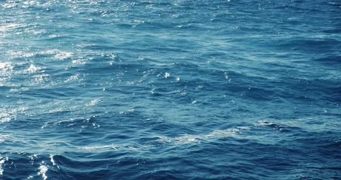 Slow motion close up of disturbed blue ocean water surface Stock Footage 325606404