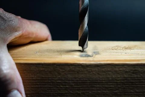 Slow motion close up of drill bit drilling into wood. Joinery and construction. Stock Photos