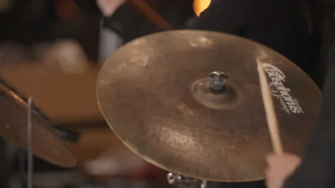 Slow motion close up of drumsticks hitting shaking cymbal, zoom in Stock Footage 204765259